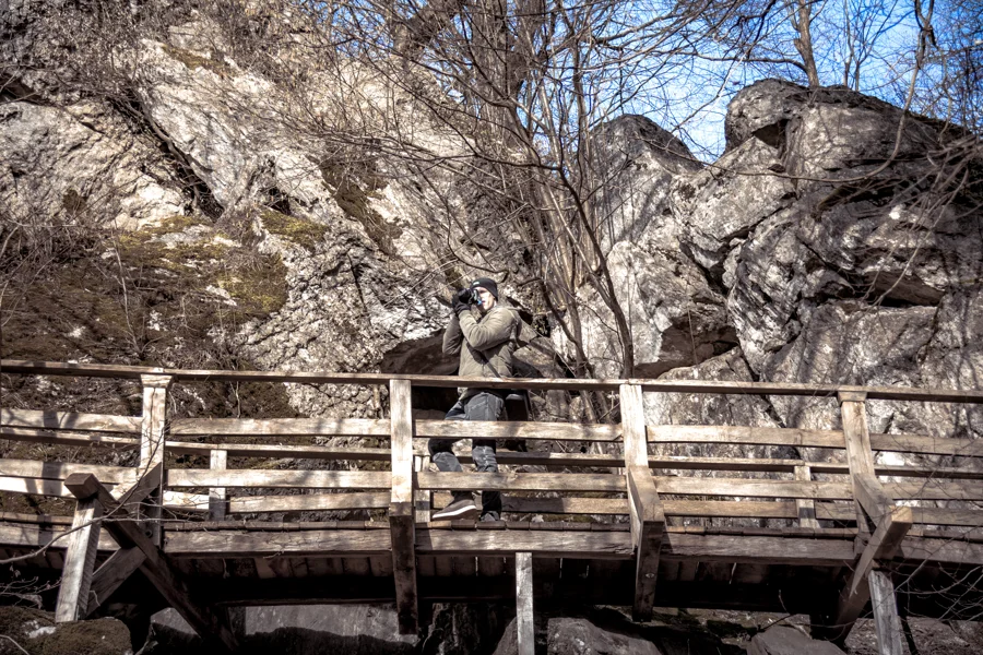 Holzbrücke vor einer Felswand